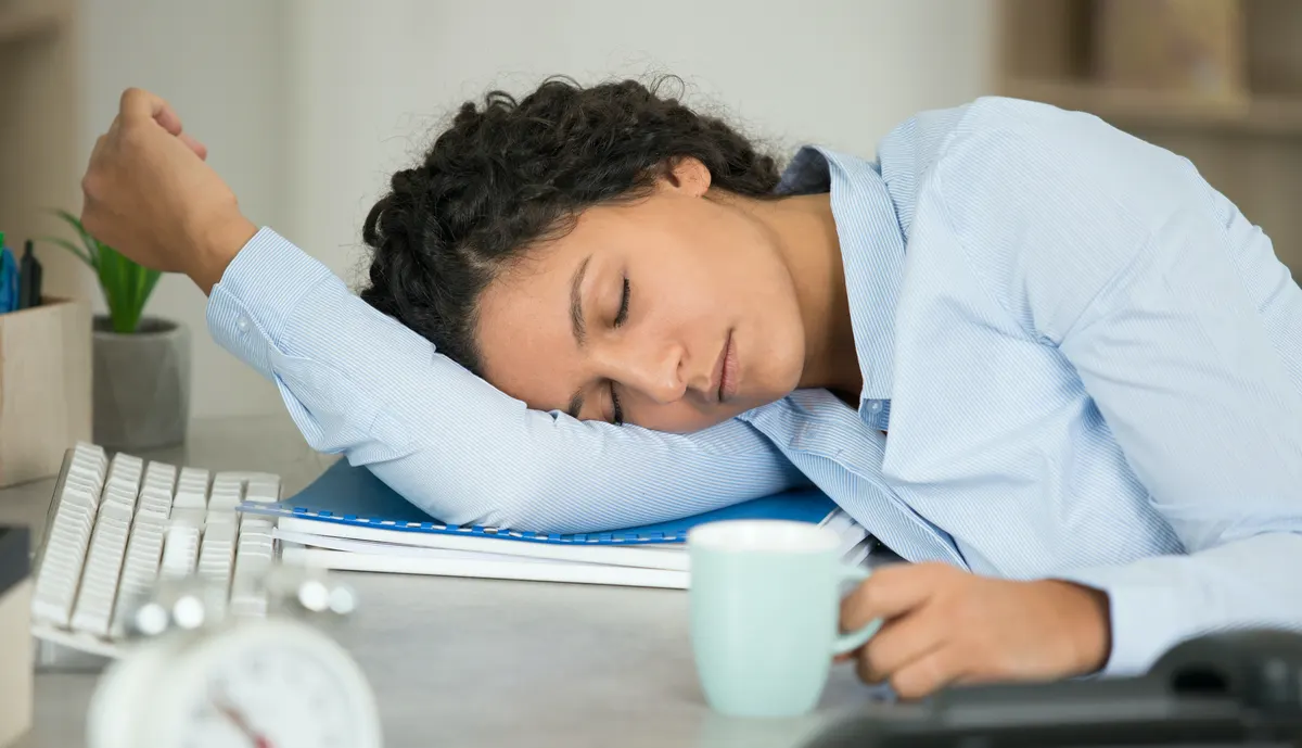 A person overcome by sleepiness during the working day